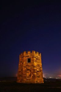 Low angle view of building against sky at night