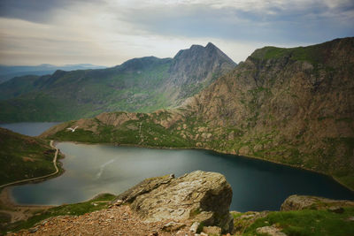 Scenic view of river and mountains against sky