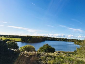 Scenic view of lake against blue sky