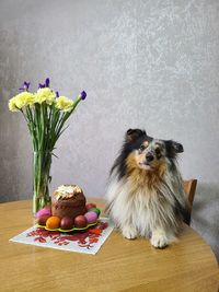 Various flowers in vase on table