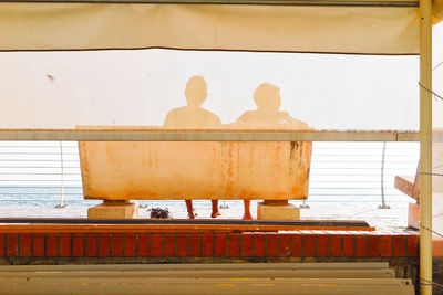 Rear view of people on wall