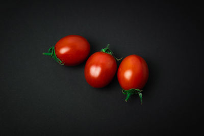 Close-up of tomatoes against black background
