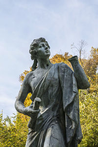 Low angle view of statue against sky in park