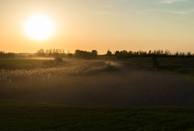 Scenic view of field against sky during sunset