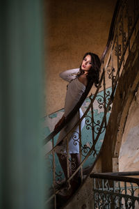 Portrait of woman standing against wall