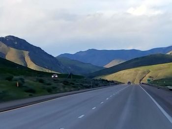 Country road leading towards mountains