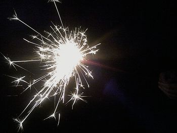 Low angle view of firework display at night