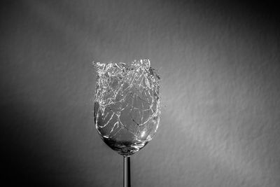 Close-up of a shattering wine glass hit by a bullet 