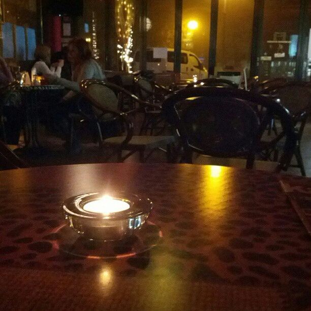 illuminated, table, indoors, night, lighting equipment, glowing, reflection, restaurant, candle, chair, burning, lit, light - natural phenomenon, flame, no people, fire - natural phenomenon, absence, dark, wineglass, decoration