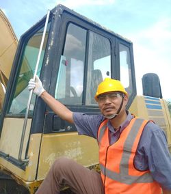 Rear view of man working against yellow