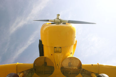 Low angle view of yellow airplane against sky