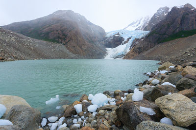 Scenic view of lake against sky during winter