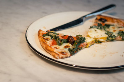 Close-up of pizza slices in plate on table