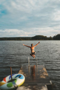 Man surfing in lake against sky