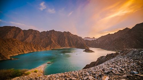 Panoramic view of sea and mountains against sky during sunset