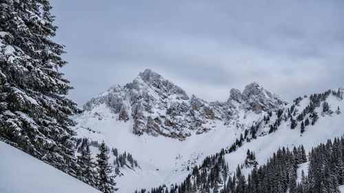 Scenic view of snow covered mountains against sky