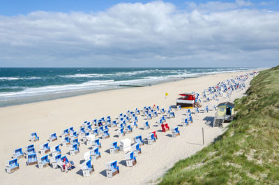 High angle view of deck chairs on beach