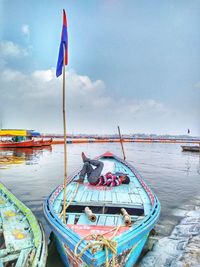 High angle view of man sleeping on boat moored in sea