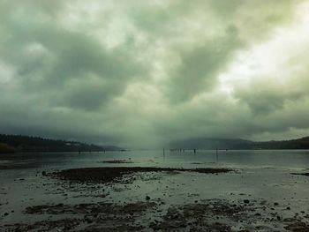 Scenic view of sea against storm clouds