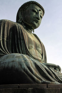 Low angle view of statue against sky