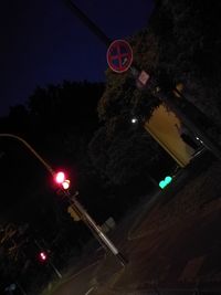 Low angle view of illuminated street light at night