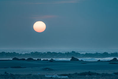 Full moon over sea at dusk