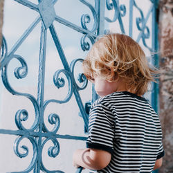 Boy looking towards window at home