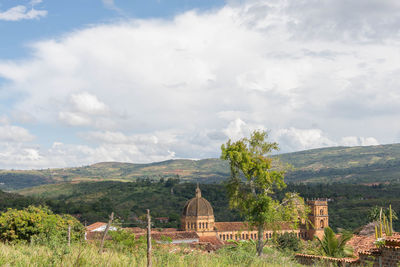 Scenic view of trees and buildings against sky