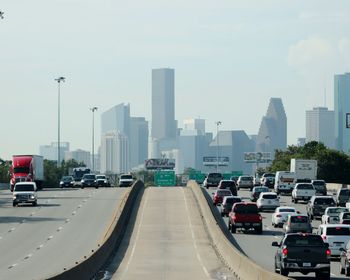 Traffic on road against buildings in city