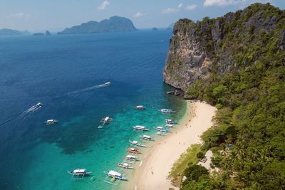 High angle view of boats on sea shore against sky