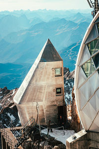 Built structure by sea against mountain