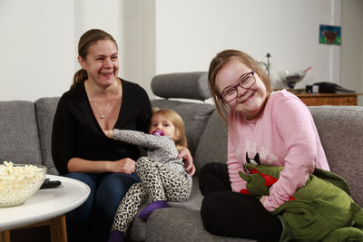 Mother with daughters on sofa