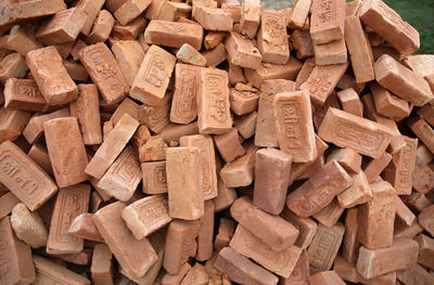 Full frame shot of pile of red bricks 