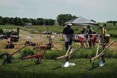 People playing golf on grassy field