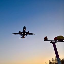 Low angle view of airplane against clear sky