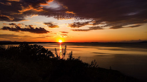 Scenic view of sea against romantic sky at sunset