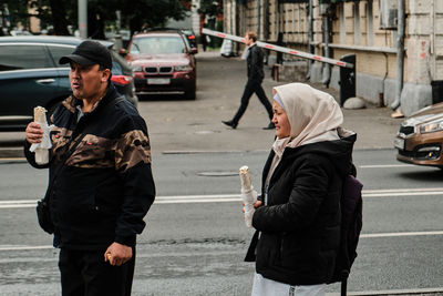 Rear view of man walking on city street