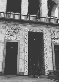 Woman standing in front of building