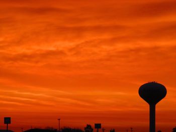 Low angle view of street light against orange sky