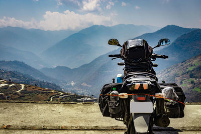 Rider loaded motorcycle with pristine natural view at hill top at morning