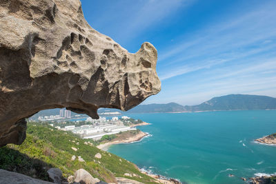 Scenic view of sea and mountains against sky