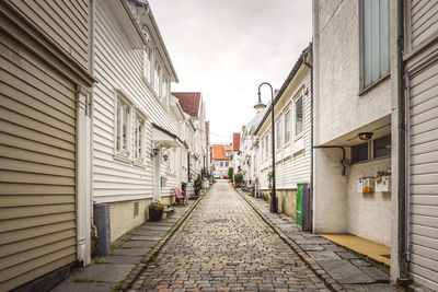 Empty alley amidst buildings in city