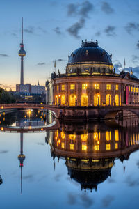 Illuminated buildings in water at night