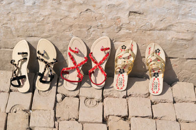 High angle view of shoes on brick wall