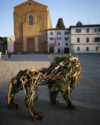 Horse cart on street against buildings in city