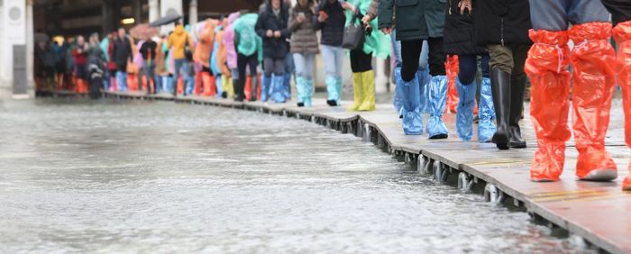 Low section of people standing on street