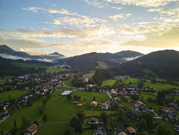 High angle view of townscape and mountains against sky