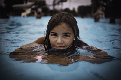 Portrait of boy swimming in pool