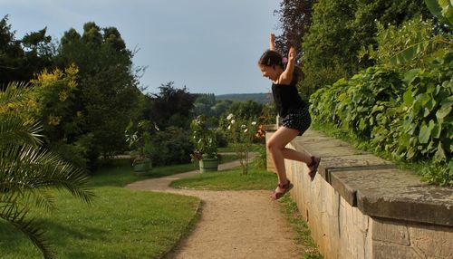 Full length of woman walking on footpath