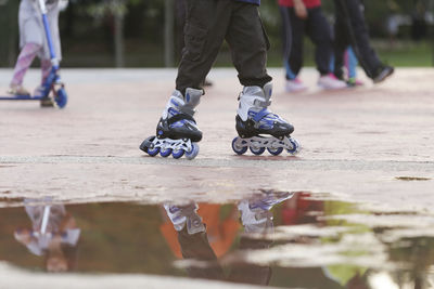 Low section of people walking on floor in city